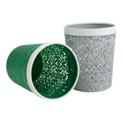 Decorative waste basket with cut‑out floral pattern in green and grey colours, finished with a white rim for home or office use